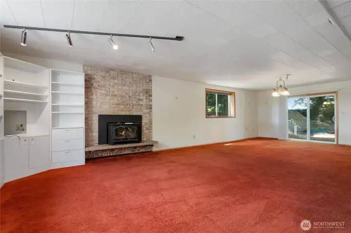 Plenty of built in shelving and a wood burning fireplace make this room appealing. There is also access to the patio and back yard.