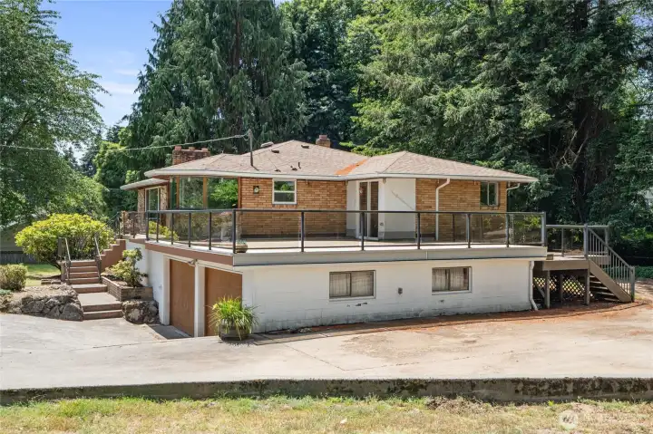 View from side of home . Look at that great deck! 2 car garage and RV parking!