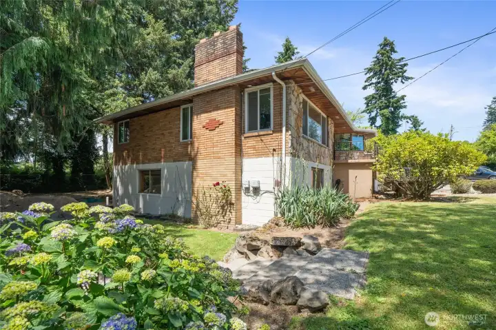 Very nice side of the yard with concrete stairs leading to the back yard & patio.