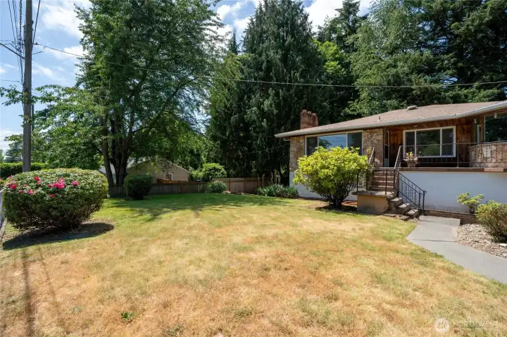 Large partially fenced front yard.