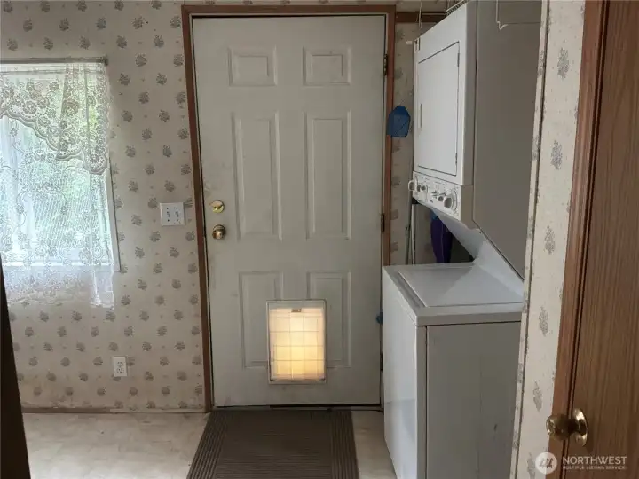 laudry room with pet door to fenced yard