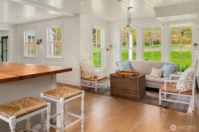 This charming nook offers flexibility as a dining area or a relaxing sitting space.