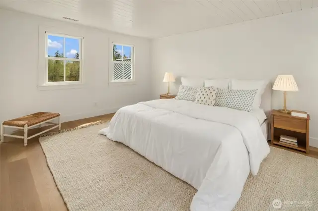 A serene retreat, where natural light fills the primary bedroom and effortlessly connects to the luxurious ensuite bath
