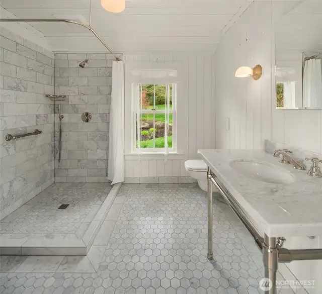 This beautifully appointed bathroom features luxurious details, perfectly complementing the downstairs flex room.