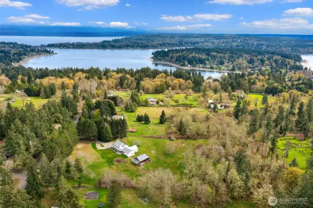 This aerial view captures the perfect blend of privacy and natural beauty, with the serene Quartermaster Harbor in the distance.