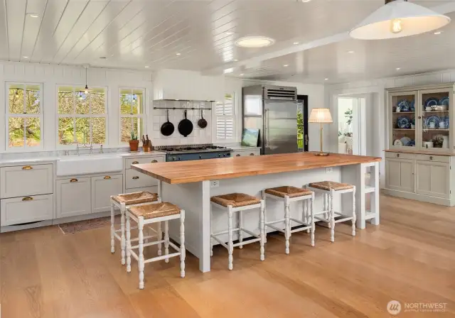 A gourmet kitchen showcases a La Cornue “Le Chateau 120” gas range, Sub-Zero refrigerator, marble countertops, and a Boos maple butcherblock island.