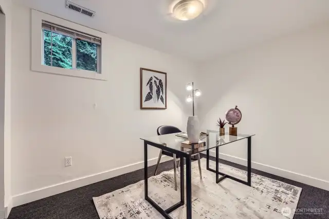 4th bedroom just off the lower level family room. Currently staged as an office.