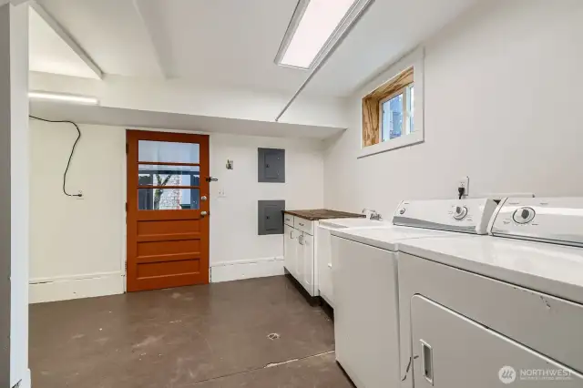 Laundry room with tub sink, folding table or work bench and abundant room for storage that cannot be seen in this photo. The door it to the carport.