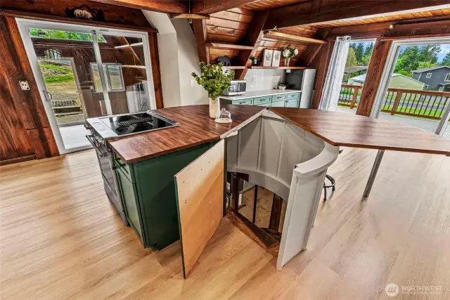 Island opens to spiral staircase descending to basement