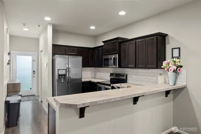 A view to the kitchen featuring a generous kitchen bar for casual dining and entertaining.