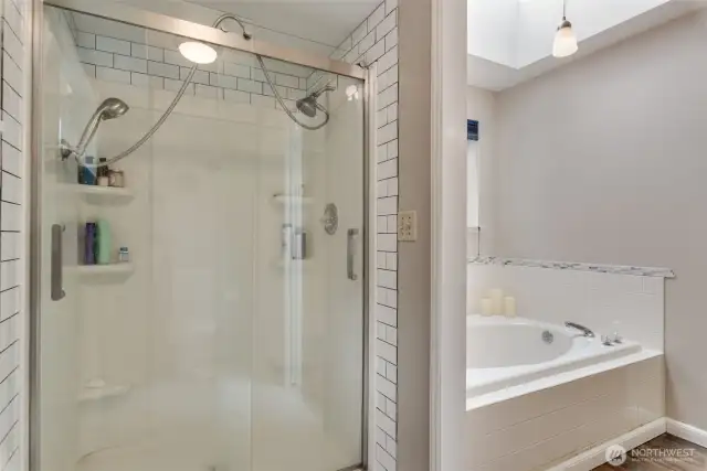Primary bathroom has a walk-in shower and soaking tub