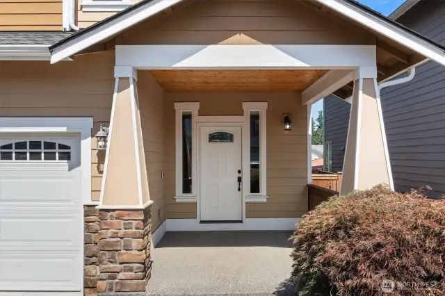 Lovely covered front porch w/wood accents!