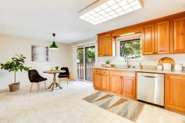 The kitchen includes plenty of space for a 2nd dining area and a sliding glass door to the big deck with stairs to the fenced back yard.