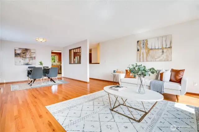 Oak hardwoods extend from the living room into the dining area, down the hall, and into all 3 upper level bedrooms.