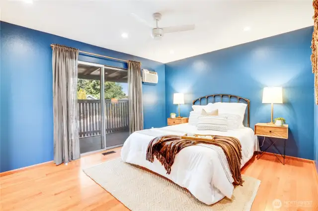 The primary suite includes a sliding door to the deck and a private 3/4 bath.