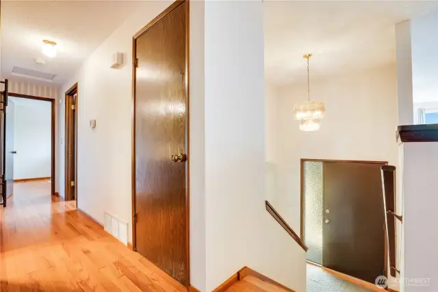 The upper hall includes this coat closet right at the top of the stairs and a built-in linen closet just outside the full bath.