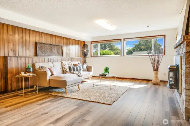 This 2nd living room with its gas fireplace and good natural light was used these last 5 years as a full-time art studio. It's spacious and set apart from the activity of the upper level and comfortable all year with the addition of a mini-split unit.