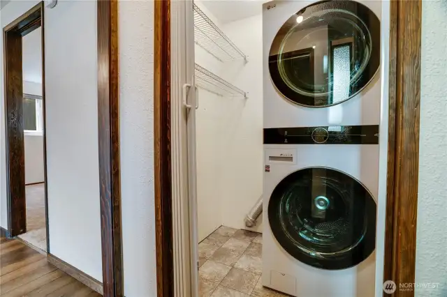 Find this stacking washer and dryer set (installed in the last 5 years) at the foot of the stairs.