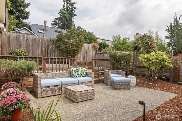 Private and fenced backyard features a patio and garden space.