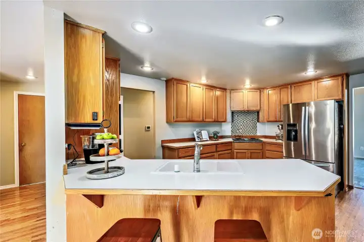 Kitchen features a very useful breakfast bar with seating area.