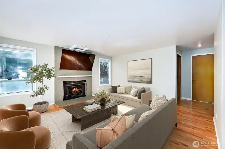 Family room with gas fireplace. *TV doesn't convey. Other furniture is digitally staged.