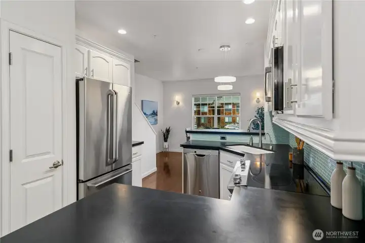 Pantry, bar seating on either side of kitchen
