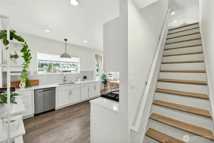 Stairs to the large loft bedroom and 1/2 bath.
