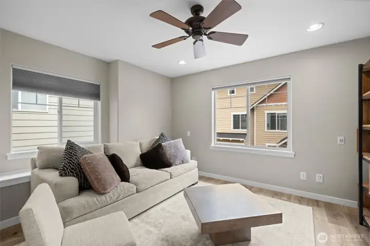Custom blinds have been added to each vinyl window and the ceiling fan has been installed for comfort.