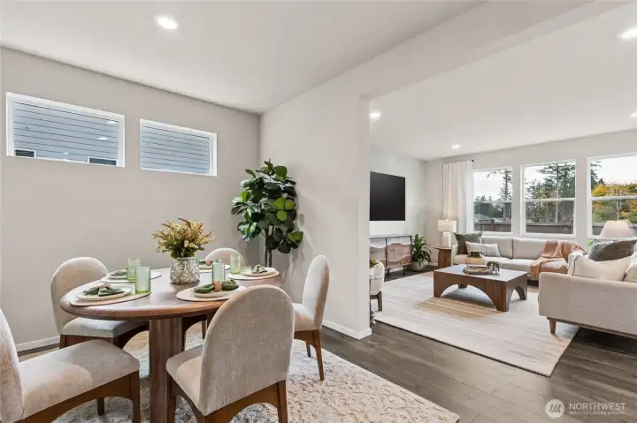 Dining room with transom windows leading into great room. Finishes and options will vary.