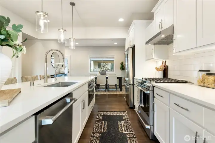 Gourmet kitchen with quartz counters and stainless appliances.