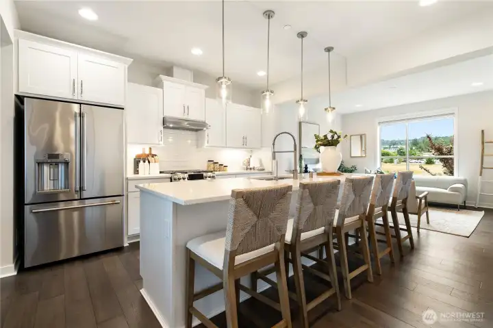 The kitchen anchors the space, creating a natural gathering spot.