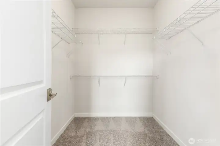 Primary bedroom walk in closet