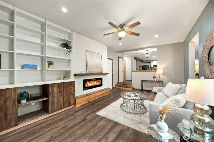 Family room with fireplace, custom mantel, & book shelves