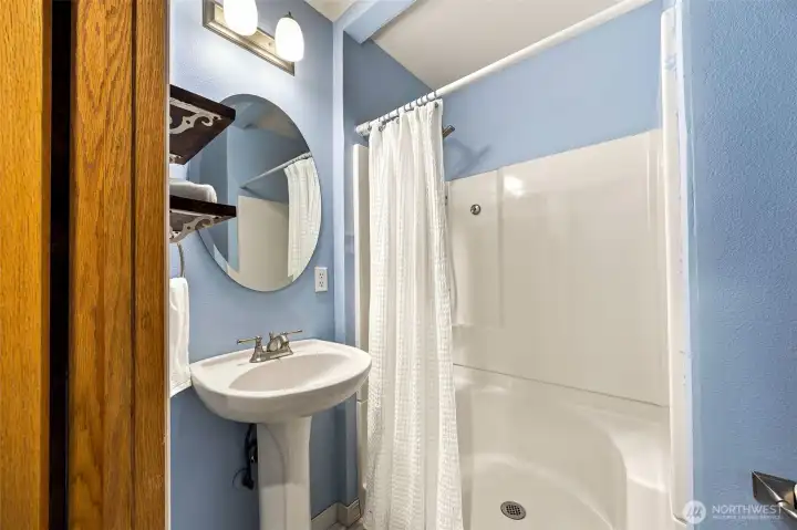 Between the front living room and kitchen is an updated 3/4 bath