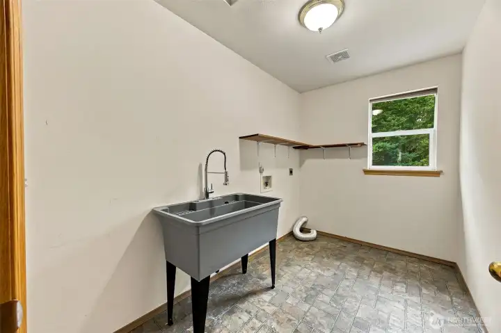 Upstairs laundry room with utility sink