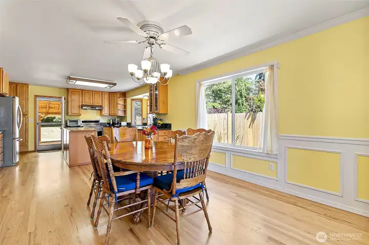 Just off the kitchen is an impressive sized dining area with chair railing and ceiling fan- as you can see there is plenty of room for an even larger table.