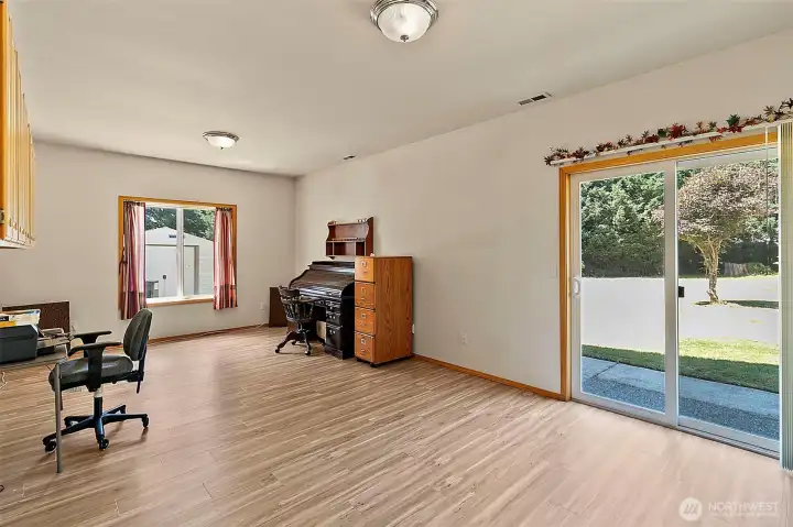 Family room with LVP flooring and sliding door out to back yard.