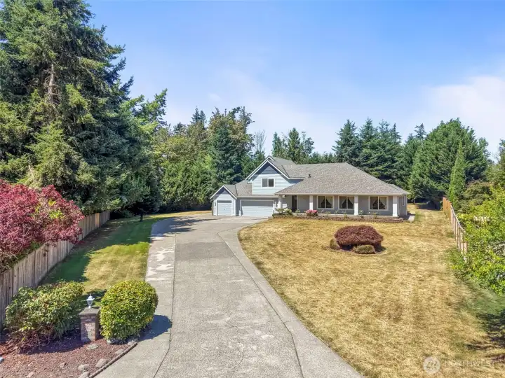 Beautiful lawn and sweeping long driveway.