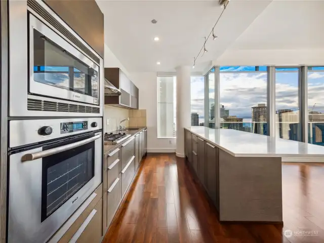 Enjoy spectacular views of the water and city skyline right from the kitchen, where sleek design meets breathtaking scenery.