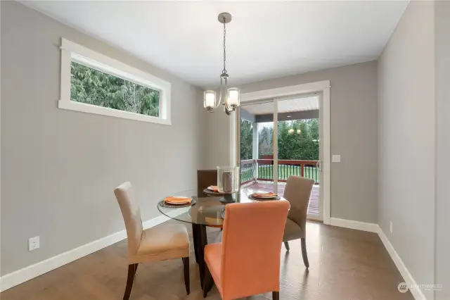 Informal kitchen eating area with sliders to covered back deck for entertaining