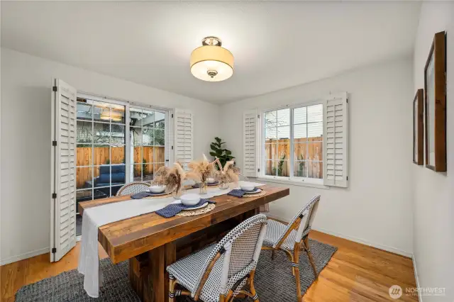 Formal dining room with sliding glass door to trellis and paver side yard.