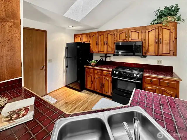 Kitchen is open to great room and dining with hardwood flooring, ideal for entertaining.