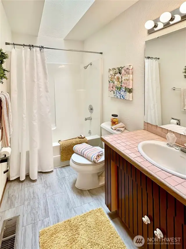 Hall bath with new flooring and skylight.