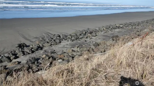 View of the Rock Bulkhead behind the lot along the Beach (looking Northwest/West).