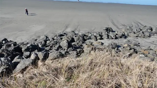 View of the Rock Bulkhead behind the lot along the Beach (looking West).