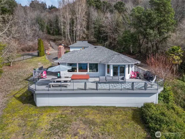 Expansive view deck with easy access from the upper level living areas and along both sides to front of house.