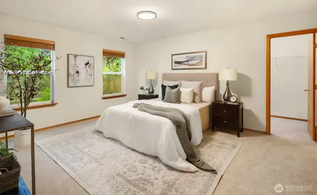 Main floor second Primary Suite overlooks the lush landscape and is a lovely guest suite. The spacious room with plenty of storage and room for a sitting area also provides comfort for long-term visitors.