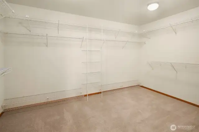 This fantastic walk-in closet has plenty room for a dresser and ottoman or bench providing elegance and additional storage.