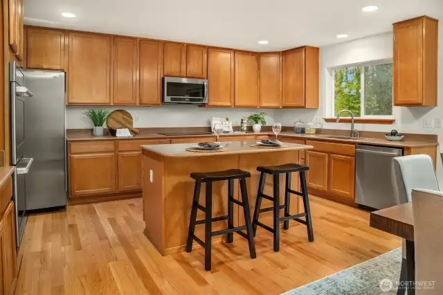 Warm and inviting Kitchen with miles of maple cabinetry, granite surfaces and SS appliances
