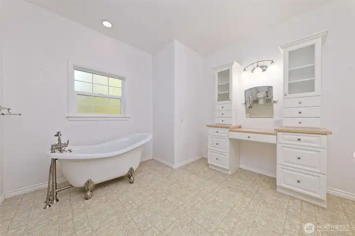 Primary bathroom with claw-foot tub, as well as there is a walk-in shower. Nice vanity.